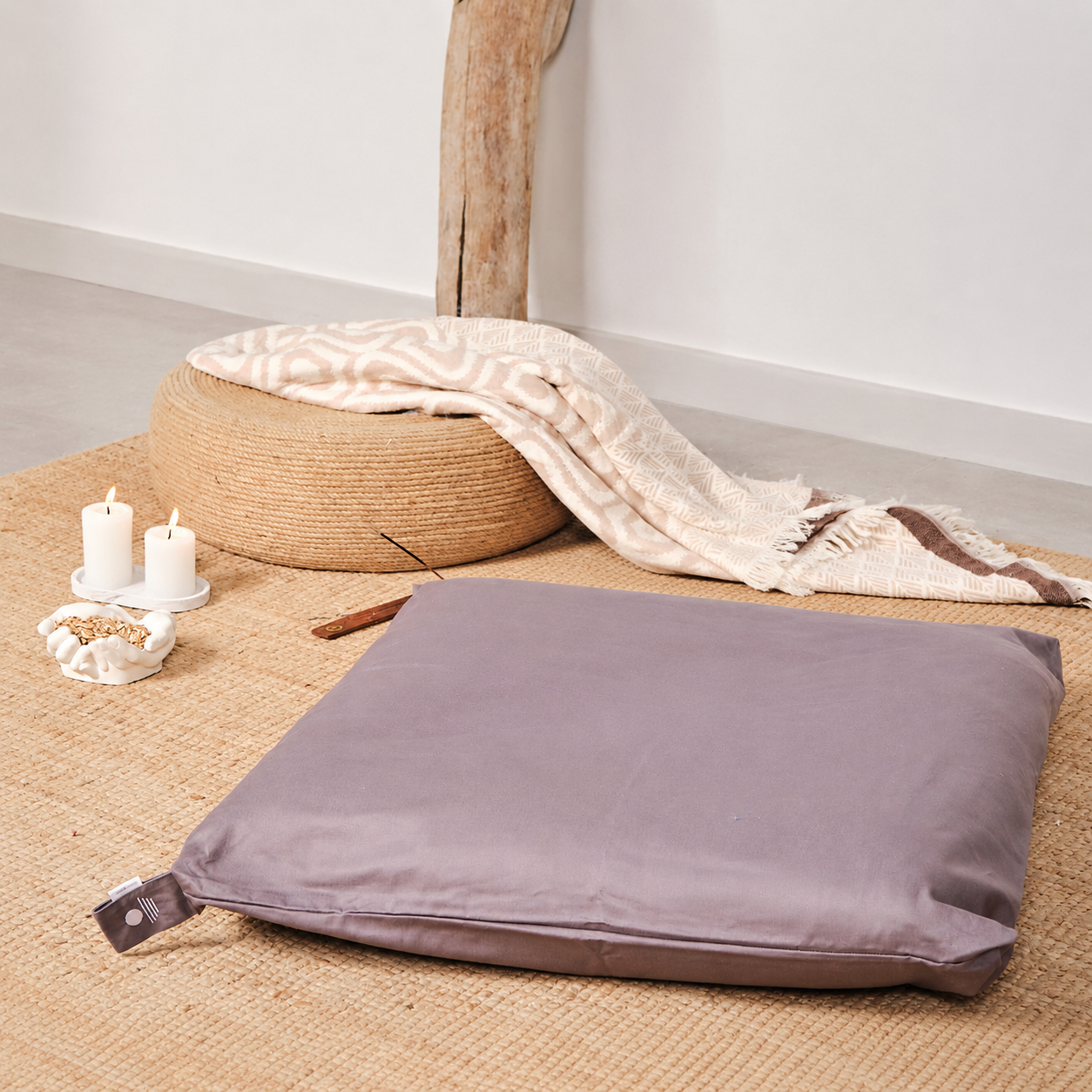 Anthrazit Zabuton Meditationsmatte auf Jutematte in ruhiger Meditationsecke mit Kerzen als Meditation Zubehör